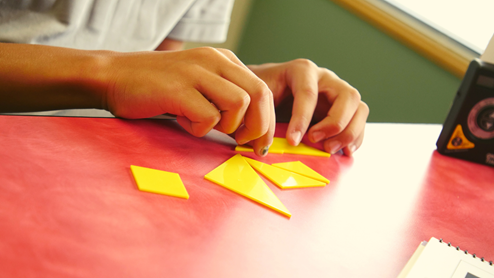 A student using shapes on a table during a cognitive training session at LearningRx