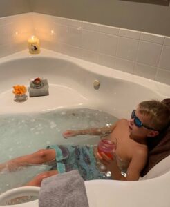 child in bathtub, decompressing child, relaxed child